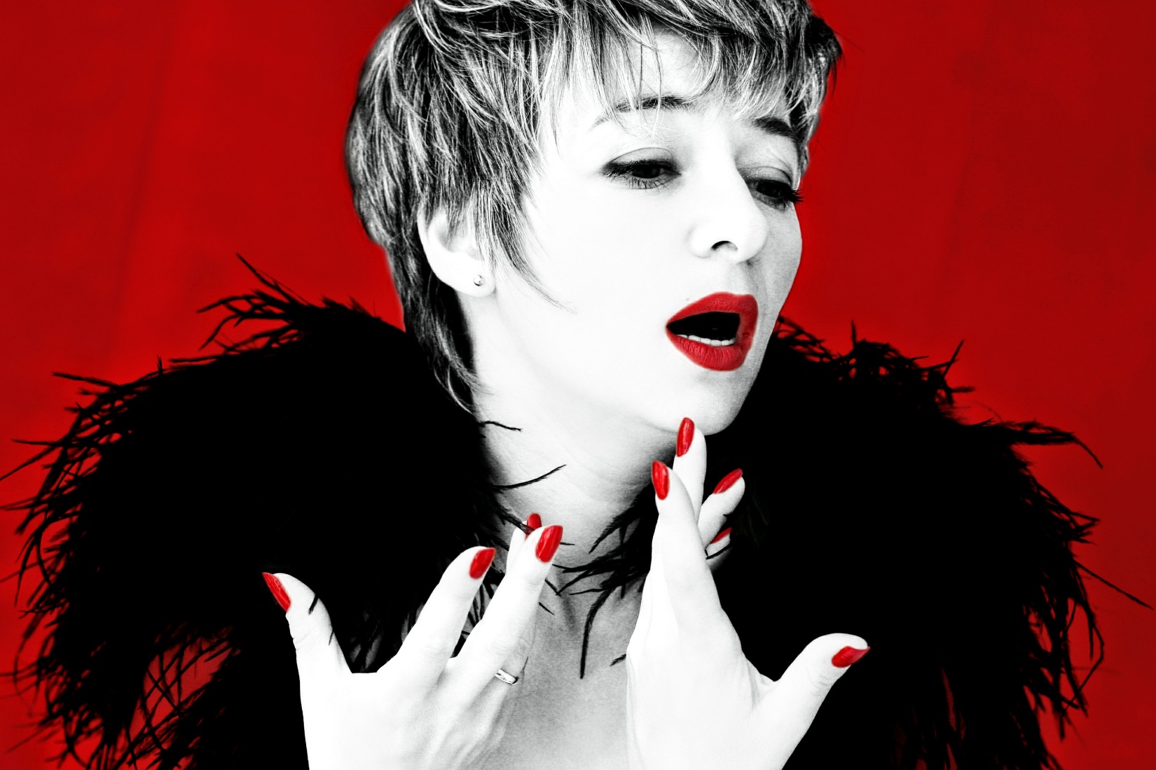 Woman in black with red background