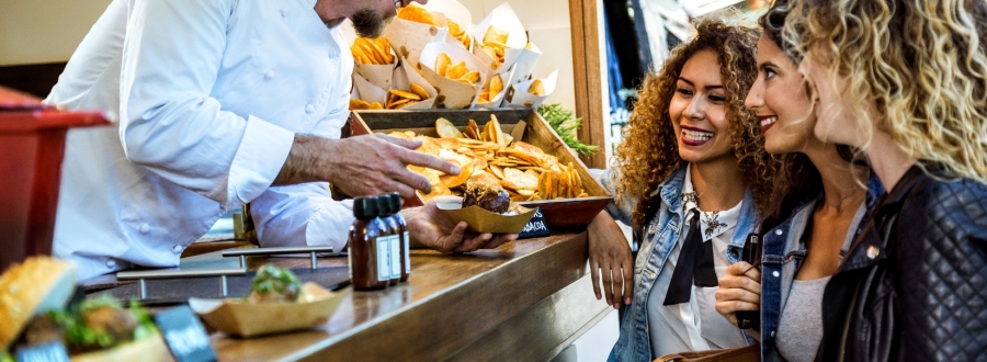 Food vendor showing three girls food