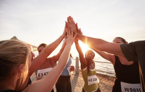 Group of runners high fiving