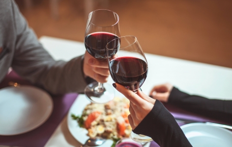 Couple toasting with their glasses of red wine