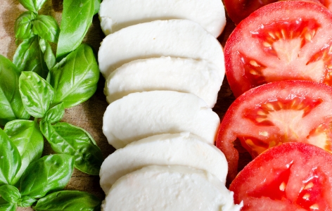 Neat rows of basil, mozzarella, and tomatoes