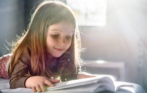 Little girl reading a book